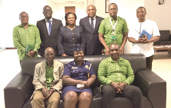 Mr Daniel Asiedu (seated right)) in a group picture with ACP, Maame Yaa Tiwaa Addo-Danquah (seated middle) and other officials of the bank and the Divisional Command.